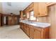 Kitchen and attached room featuring wood paneling, linoleum floors, and a ceiling fan at 3951 Lindley Dr, Powder Springs, GA 30127