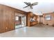 Kitchen and attached room featuring wood paneling, linoleum floors, a ceiling fan and sliding glass doors at 3951 Lindley Dr, Powder Springs, GA 30127