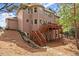 Exterior of home showing an elevated wooden deck with stairs leading down to a landscaped backyard at 403 Mill Xing, Canton, GA 30114