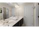 Bright bathroom featuring double vanity with white countertops and black cabinets at 403 Mill Xing, Canton, GA 30114