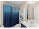 Small bathroom with blue shower curtain and shelving unit at 403 Mill Xing, Canton, GA 30114