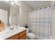 Bathroom with large mirror, vanity, and a shower with decorative curtain at 403 Mill Xing, Canton, GA 30114