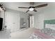 Bright bedroom featuring ceiling fan, double closets, and windows with natural light at 403 Mill Xing, Canton, GA 30114