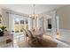 Elegant dining room featuring wainscoting, a chandelier, and a large window overlooking the backyard at 403 Mill Xing, Canton, GA 30114