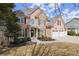 Beautiful two-story home with a well-manicured front yard, featuring a three-car garage and stone accents at 403 Mill Xing, Canton, GA 30114