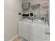 Clean laundry room with washer, dryer, and overhead storage shelves at 403 Mill Xing, Canton, GA 30114