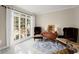 Cozy living room featuring elegant chairs, marble floors, a table, and a bright window showcasing natural light at 403 Mill Xing, Canton, GA 30114