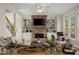 Inviting living room featuring a stone fireplace, built-in shelving, hardwood floors, and comfortable seating at 403 Mill Xing, Canton, GA 30114