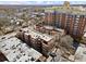 A high-angle shot displays the property surrounded by trees with a tall brick building nearby at 746 N Highland Ne Ave # 11, Atlanta, GA 30306