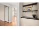 Hallway showcasing hardwood floors, picture display, and a view into bedroom at 746 N Highland Ne Ave # 11, Atlanta, GA 30306