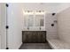 Bathroom with dual vanities, granite countertops, and a glass-enclosed shower at 898 Center Hill Nw Ave, Atlanta, GA 30318