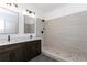 Modern bathroom with double vanity, stylish lighting, and a frameless glass shower at 898 Center Hill Nw Ave, Atlanta, GA 30318