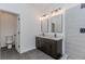 Well-lit bathroom featuring a double vanity with a granite countertop and a glass-enclosed shower at 898 Center Hill Nw Ave, Atlanta, GA 30318