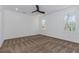 Empty bedroom with large windows overlooking the trees, a ceiling fan and neutral carpet at 898 Center Hill Nw Ave, Atlanta, GA 30318