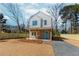 Inviting two-story home with a covered porch, stone accents and a well manicured gravel driveway at 898 Center Hill Nw Ave, Atlanta, GA 30318