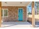 Welcoming front porch with stone detailing and a bright blue door at 898 Center Hill Nw Ave, Atlanta, GA 30318