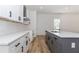 Bright kitchen with white cabinets, white countertops, stainless vent hood, light hardwood floors, and gray kitchen island at 898 Center Hill Nw Ave, Atlanta, GA 30318