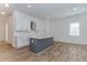 Bright open kitchen with white cabinets, a gray island, stainless vent hood, and light hardwood floors at 898 Center Hill Nw Ave, Atlanta, GA 30318