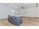 Modern kitchen island with stainless steel appliances and light hardwood floors in a brightly lit, open space at 898 Center Hill Nw Ave, Atlanta, GA 30318