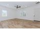 Bright open space with modern ceiling fan, light hardwood floors, and two windows at 898 Center Hill Nw Ave, Atlanta, GA 30318