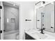 Modern bathroom highlighting black fixtures, white walls and a shower-tub combination at 907 Oakhill Sw Ave, Atlanta, GA 30310