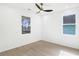 Bedroom featuring a ceiling fan, light hardwood floors, and windows offering plenty of natural light at 907 Oakhill Sw Ave, Atlanta, GA 30310