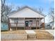 Inviting home featuring a raised porch, stairs, and a well-manicured front lawn at 907 Oakhill Sw Ave, Atlanta, GA 30310