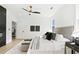 Bright main bedroom with white walls, a ceiling fan, light hardwood floors and a large window at 907 Oakhill Sw Ave, Atlanta, GA 30310