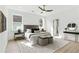 Bright main bedroom featuring a ceiling fan, light hardwood floors, and large windows at 907 Oakhill Sw Ave, Atlanta, GA 30310