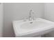 Bright bathroom featuring a pedestal sink with chrome faucet and hardware against a white wall at 1324 Parc Bench Rd, Atlanta, GA 30316