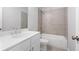 Clean bathroom featuring white vanity, tub and tiled shower, and gray tile flooring at 1324 Parc Bench Rd, Atlanta, GA 30316