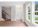 Inviting entryway featuring wood-look floors, natural light from the large windows, and a staircase at 1324 Parc Bench Rd, Atlanta, GA 30316