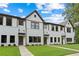 Attractive townhome showcasing a brick and siding facade, dark trim, and manicured lawns at 1324 Parc Bench Rd, Atlanta, GA 30316