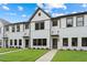 Charming townhome featuring a white brick facade, dark trim, and a well-maintained lawn at 1324 Parc Bench Rd, Atlanta, GA 30316