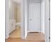 Hallway showcasing a full bathroom with tiled shower/bath, and a white interior door at 1324 Parc Bench Rd, Atlanta, GA 30316