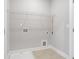 Functional laundry room with overhead shelving, utility sink, and tile flooring at 1324 Parc Bench Rd, Atlanta, GA 30316