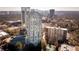 Stunning aerial view of high-rise condo building with skyline views, swimming pool, and surrounding landscape at 2870 Pharr Court South Nw # 407, Atlanta, GA 30305