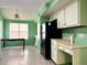 Eat-in kitchen area, green walls, a ceiling fan, and a black refrigerator at 5707 Western Hills Dr, Norcross, GA 30071