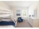 Bright bedroom featuring a bunk bed, blue chair, and dresser at 147 Silverton Dr, Dacula, GA 30019