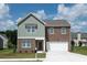 Attractive two-story home featuring a brick facade, two-car garage, and well-manicured lawn at 147 Silverton Dr, Dacula, GA 30019