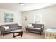 Bright living room with a gray sofas, a modern coffee table, and a large window at 147 Silverton Dr, Dacula, GA 30019