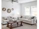 Cozy living room with a comfortable sofa, chairs, a decorative mirror set, and a wooden coffee table at 147 Silverton Dr, Dacula, GA 30019