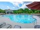 Community pool with plenty of lounge chairs and shady umbrellas provides a perfect oasis on a hot day at 147 Silverton Dr, Dacula, GA 30019