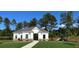 Exterior view of the community clubhouse with lush green landscaping, a playground, and a walkway at 167 Silverton Dr, Dacula, GA 30019