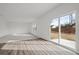 Bright living room with hardwood-style flooring and sliding glass doors to the backyard at 167 Silverton Dr, Dacula, GA 30019