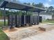 Mailbox station under a covered structure with brick accents, benches, and manicured landscaping at 167 Silverton Dr, Dacula, GA 30019