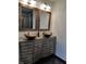 Bathroom featuring dual vanity with vessel sinks, mirrors, and rustic wood accents at 2479 Peachtree Ne Rd # 1115, Atlanta, GA 30305