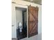 Bathroom with sliding barn door and a shower with black and white mosaic tiling at 2479 Peachtree Ne Rd # 1115, Atlanta, GA 30305