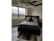 Bedroom with a large window overlooking the city and concrete ceilings at 2479 Peachtree Ne Rd # 1115, Atlanta, GA 30305