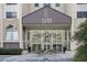 Exterior shot of the building entrance, with a modern glass facade and manicured landscaping at 2479 Peachtree Ne Rd # 1115, Atlanta, GA 30305